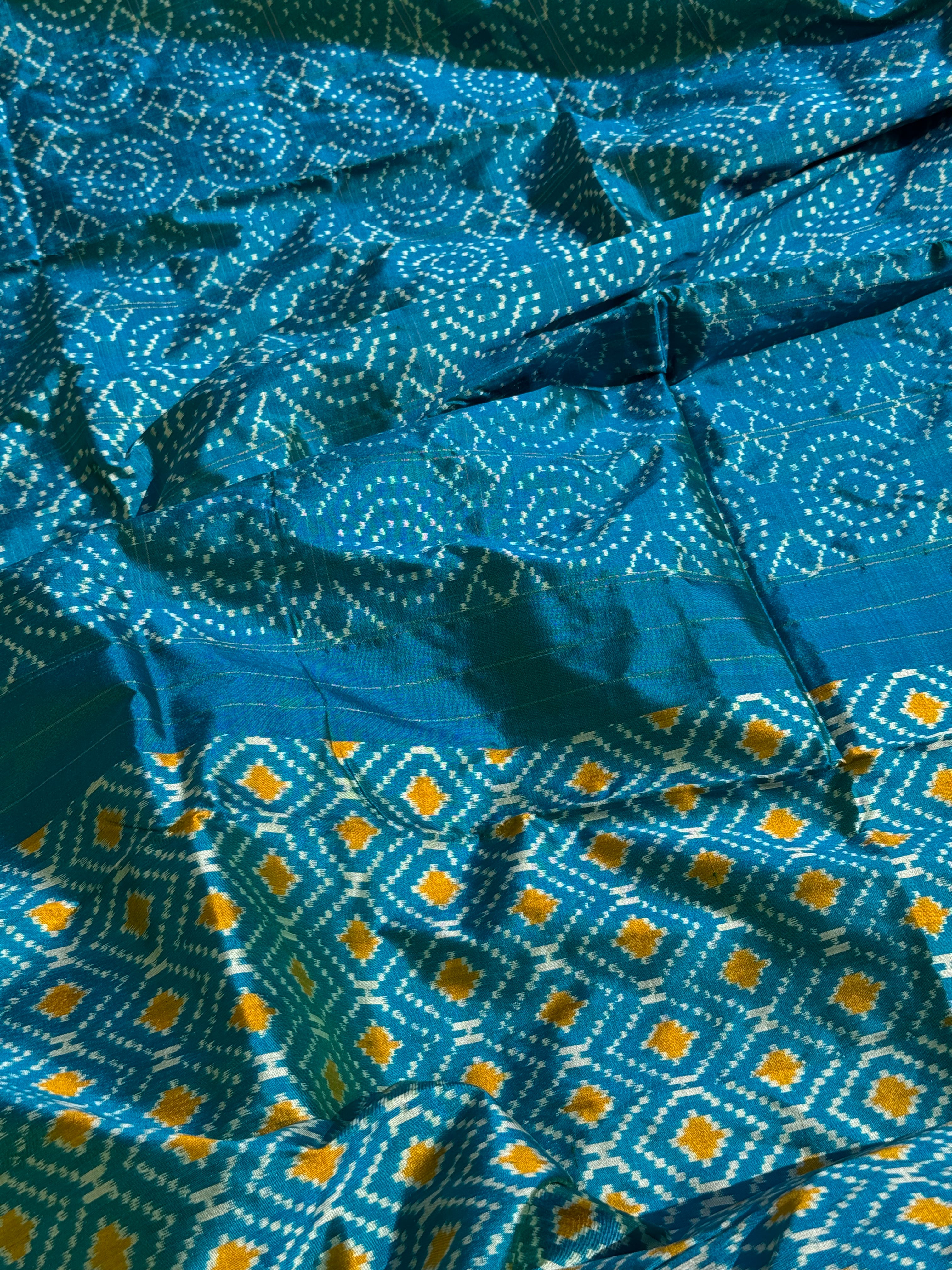 A masterpiece ikkat handwoven weft ikkat saree in pure mulberry silk in teal shade with complete zari checks on body