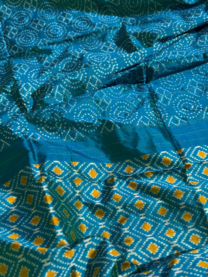 A masterpiece ikkat handwoven weft ikkat saree in pure mulberry silk in teal shade with complete zari checks on body