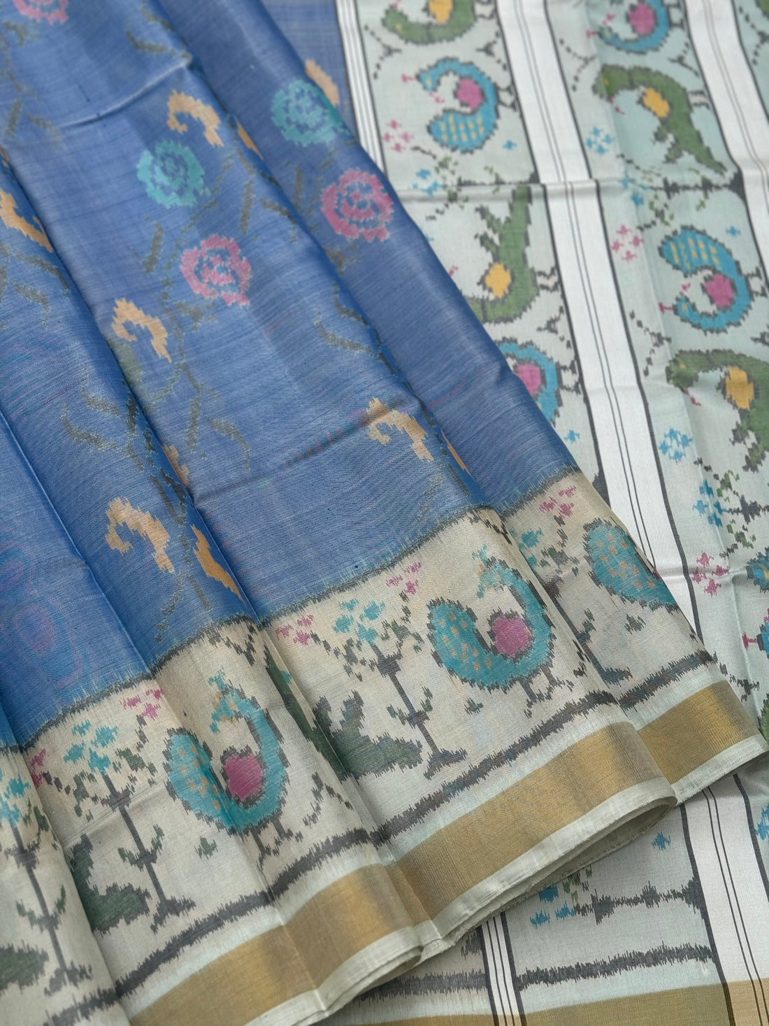 A gorgeous powder blue  with ivory  shade single ikkat patola silk saree