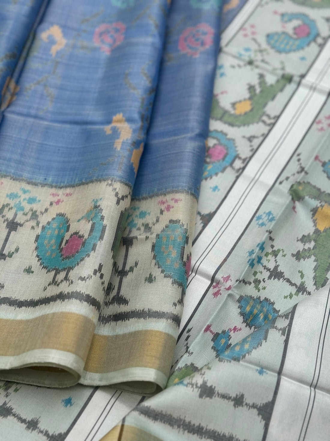 A gorgeous powder blue  with ivory  shade single ikkat patola silk saree