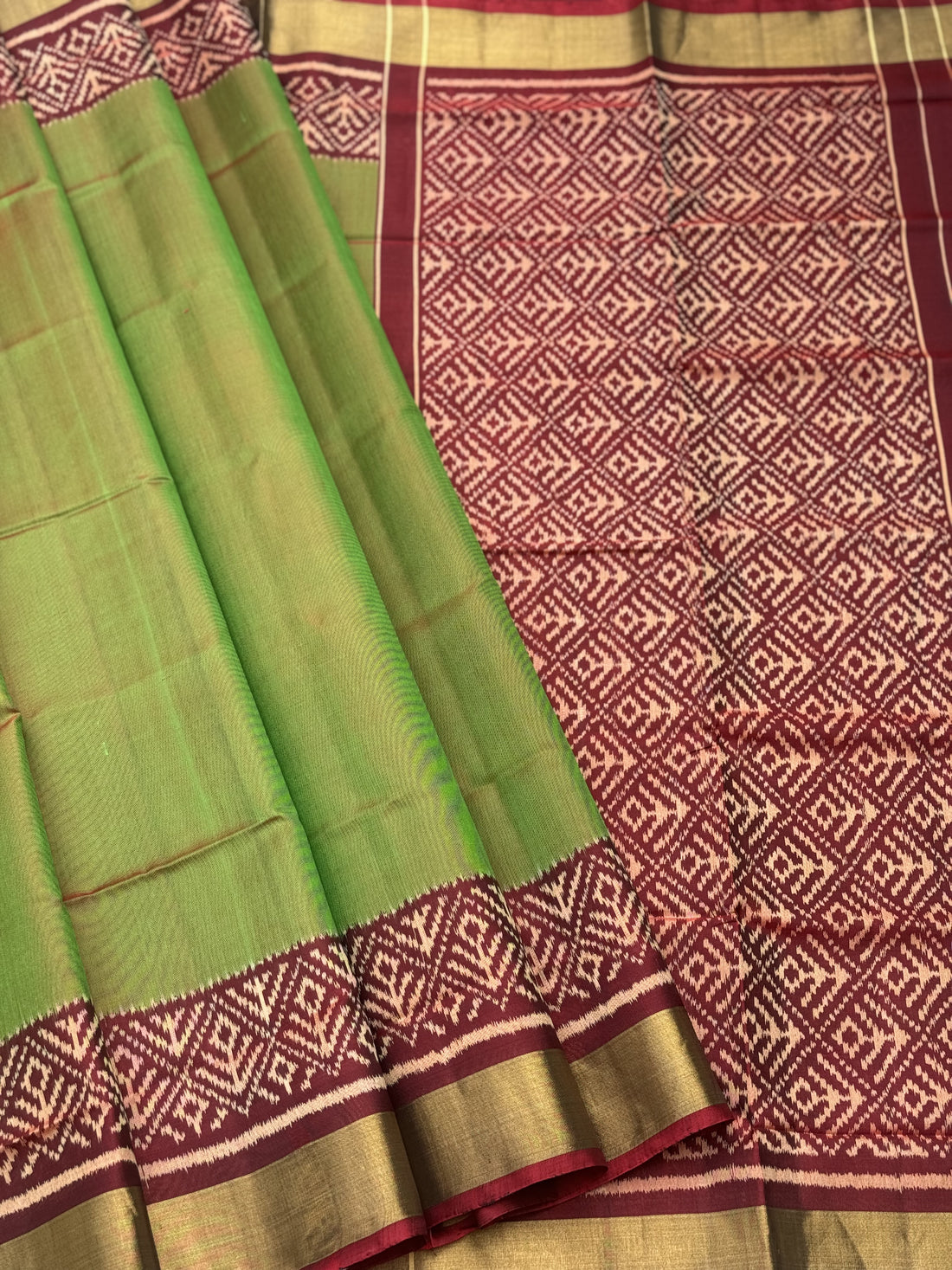 A gorgeous tender leaf green with maroon shade single ikkat patola silk Saree