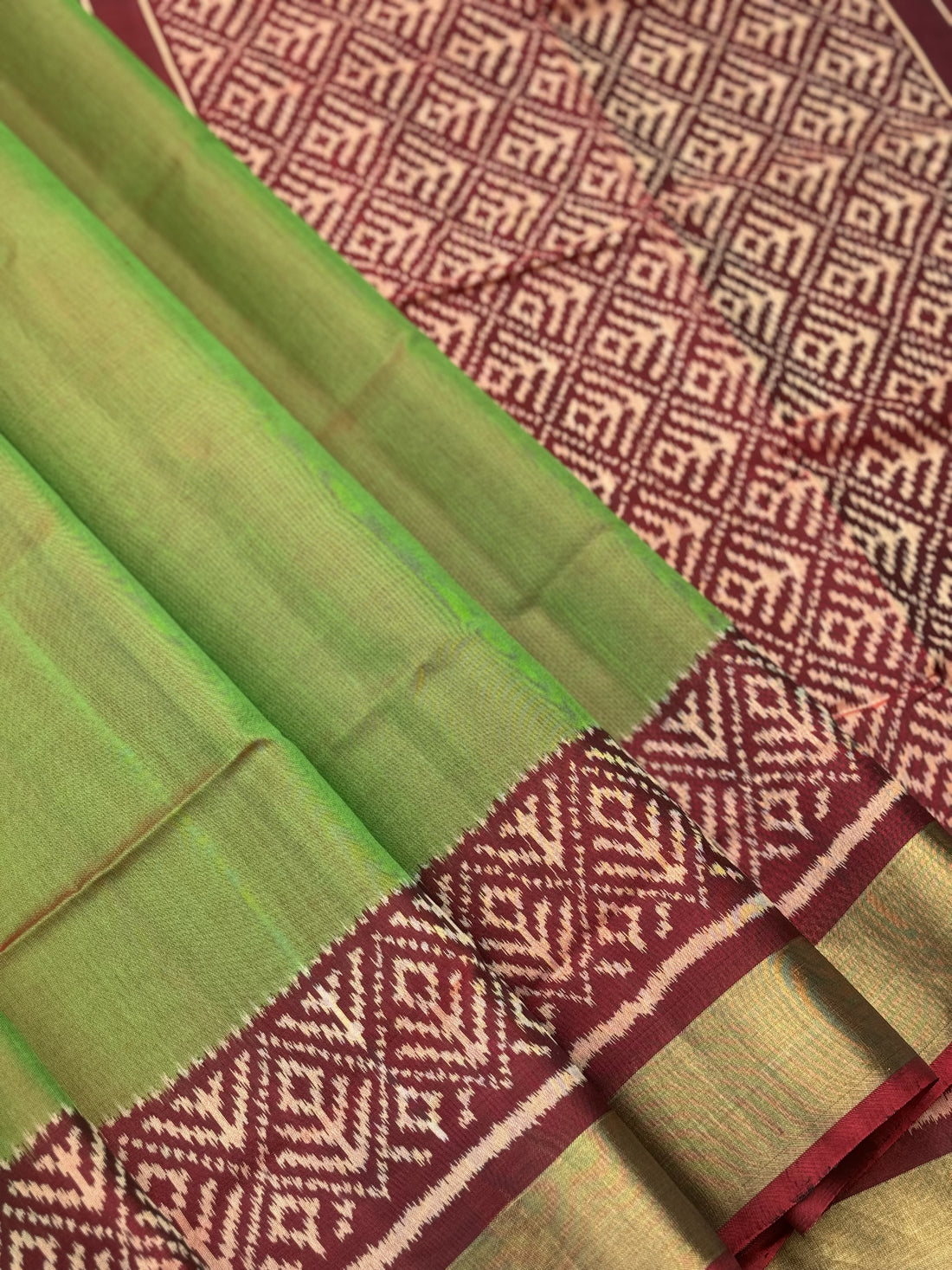 A gorgeous tender leaf green with maroon shade single ikkat patola silk Saree