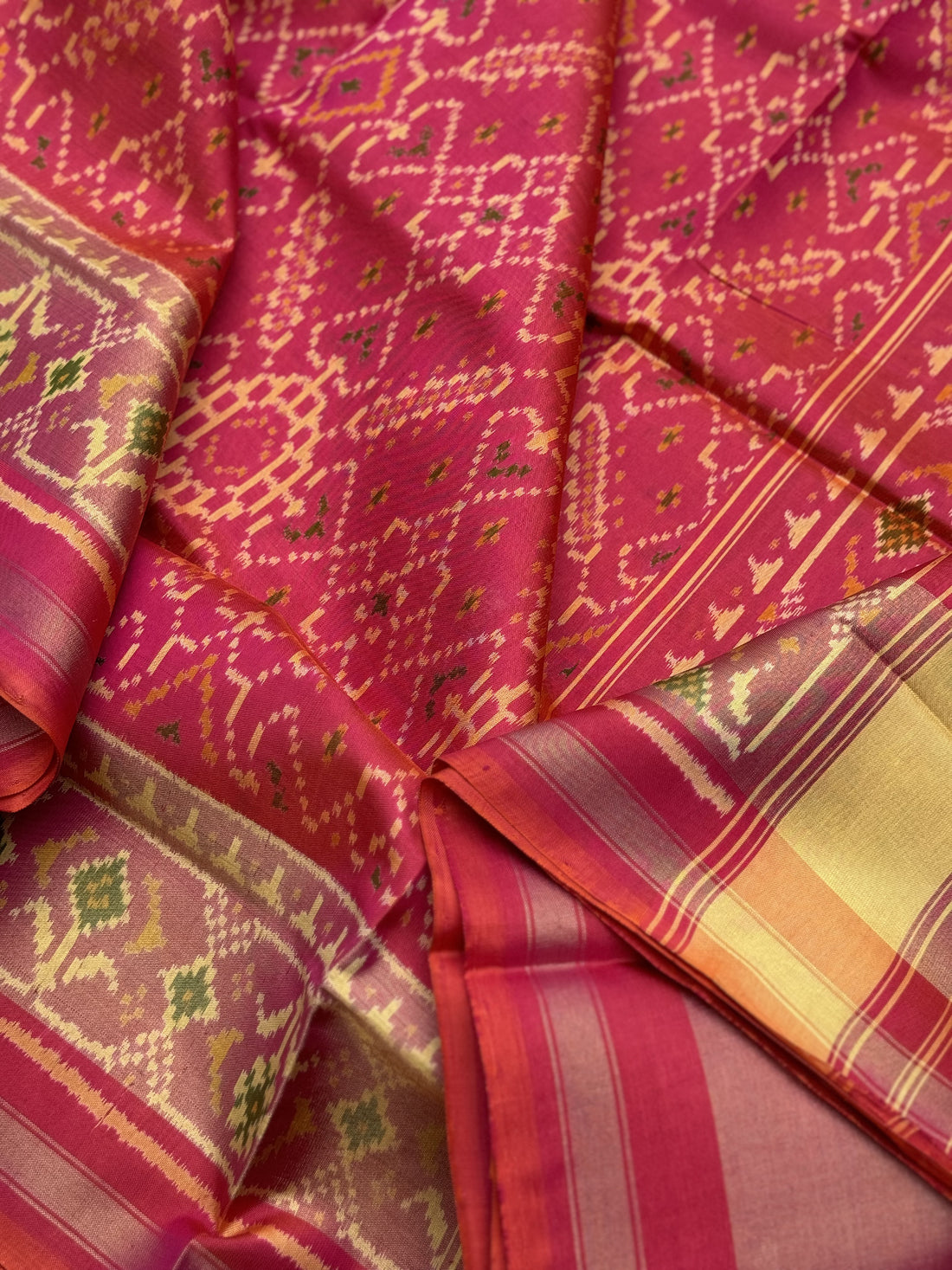 A gorgeous Peachish pink shade single ikkat patola silk Saree