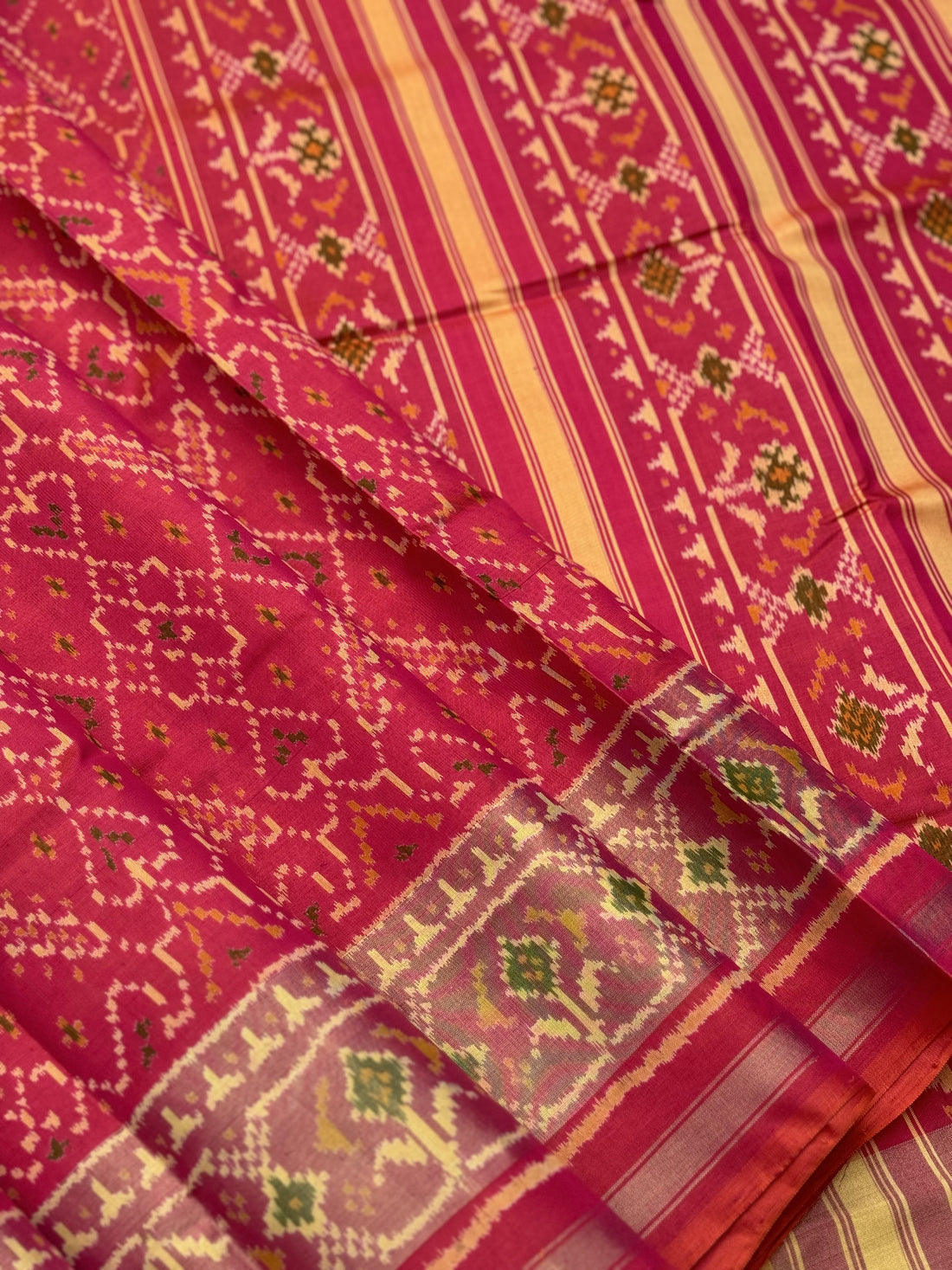 A gorgeous Peachish pink shade single ikkat patola silk Saree