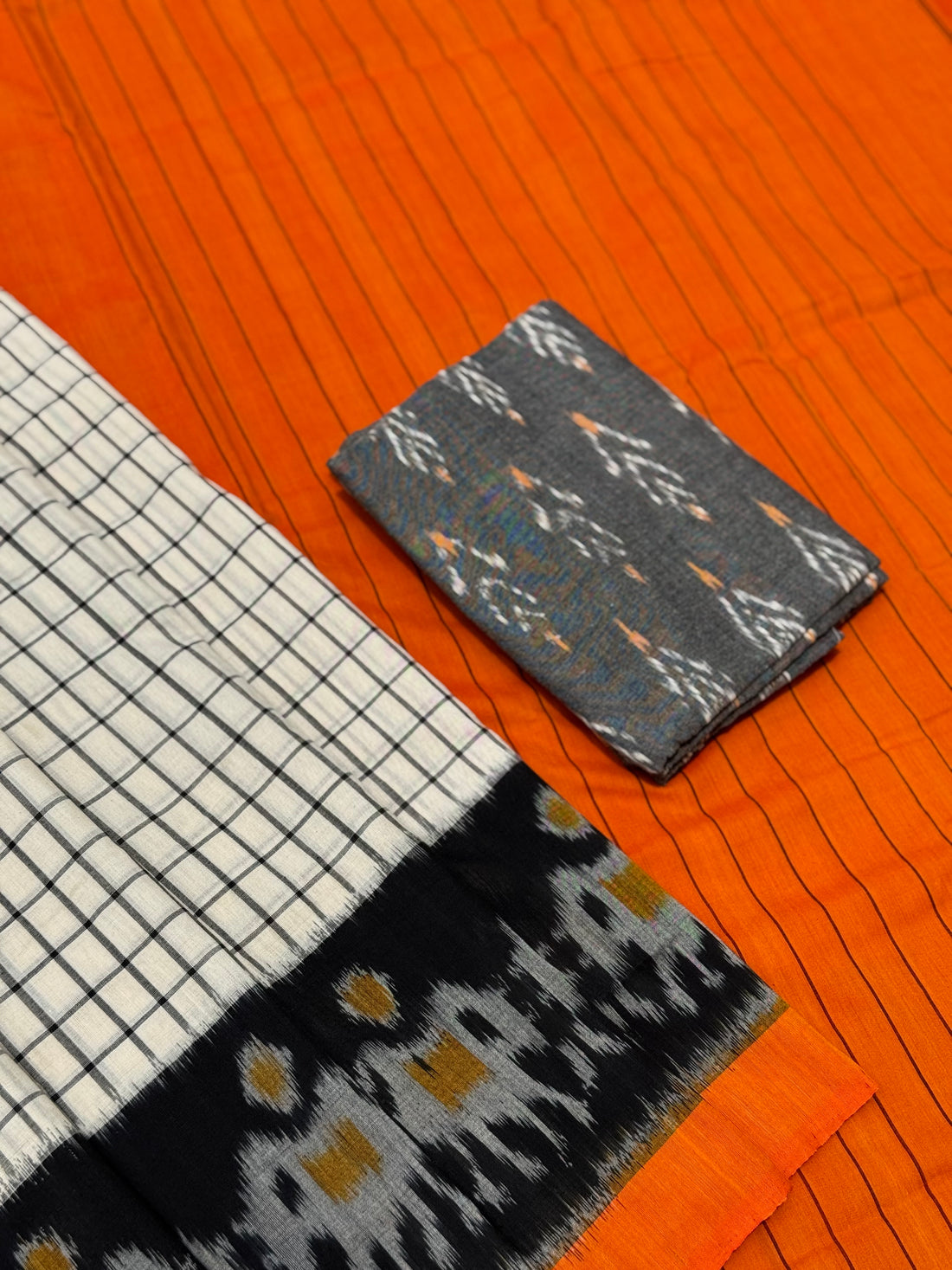 White checks with orange black handwoven weft single ikkat cotton saree