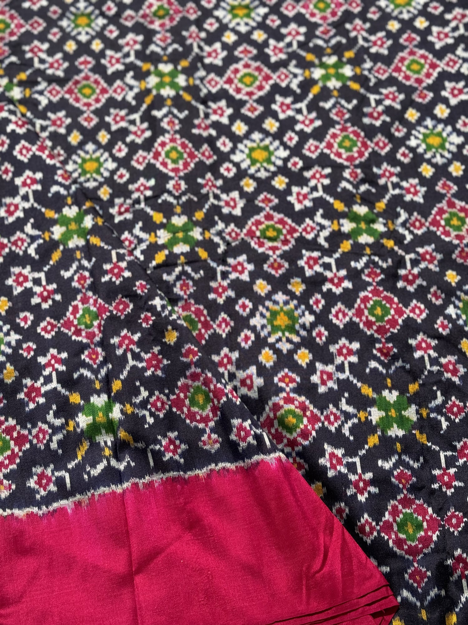 Black with pink patola inspired navratan ikkat design on pure mulberry silk fabric