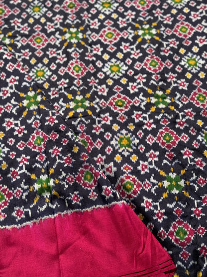 Black with pink patola inspired navratan ikkat design on pure mulberry silk fabric