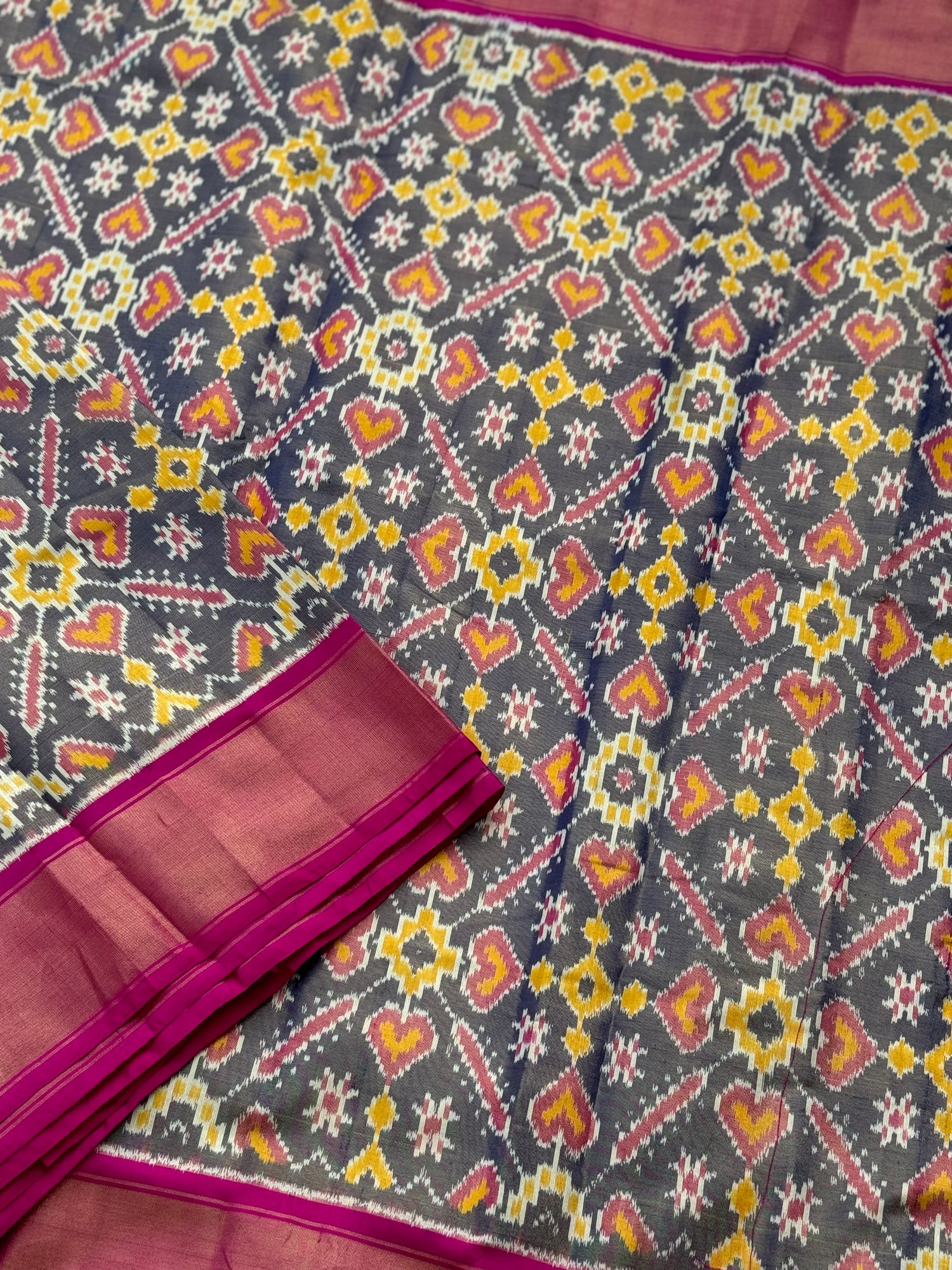 Deep bluish pink tissue patola inspired navratan ikkat design on pure mulberry silk fabric