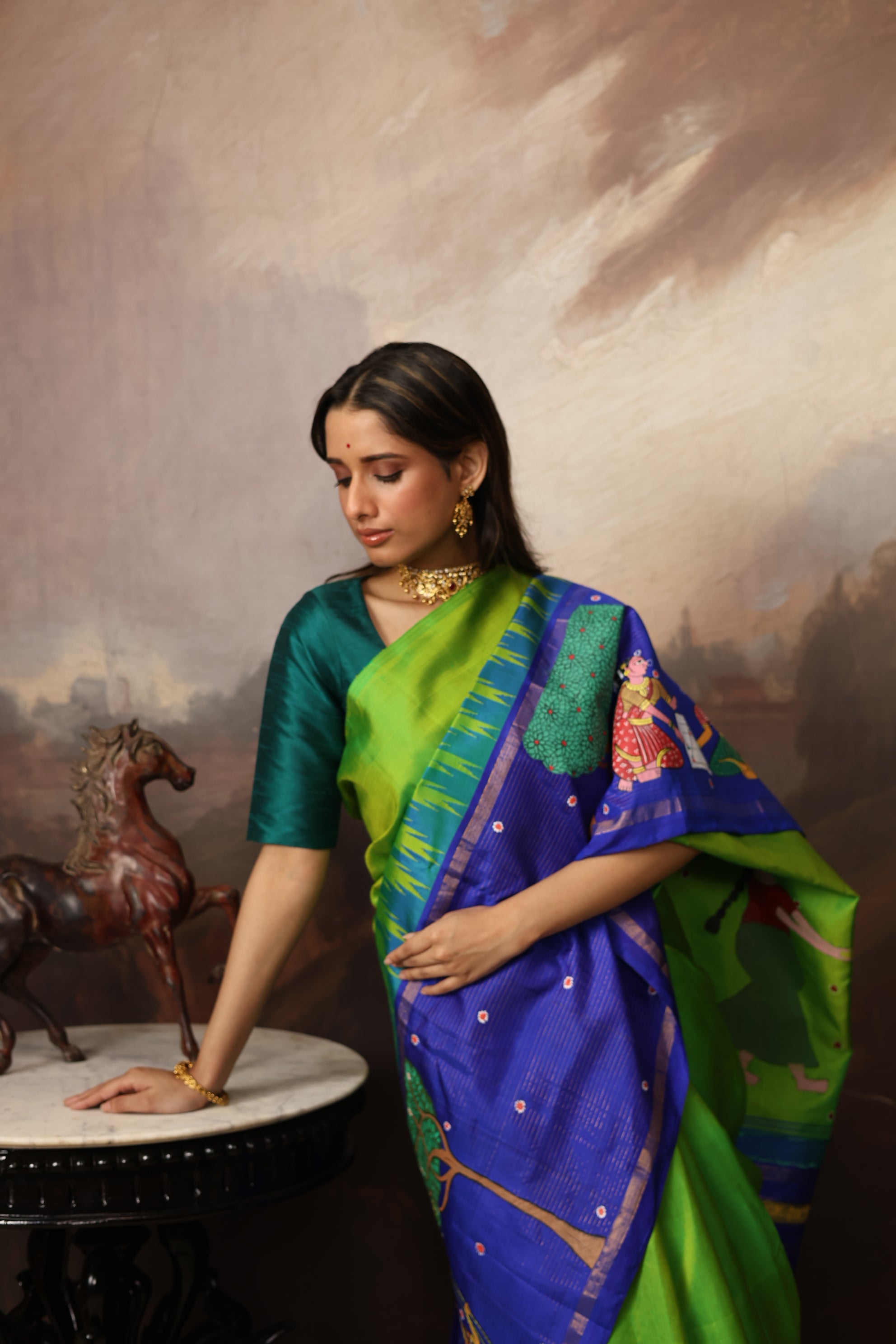 An extraordinary Cheriyal painting scroll art on a pure korvai silk kanchivaram saree